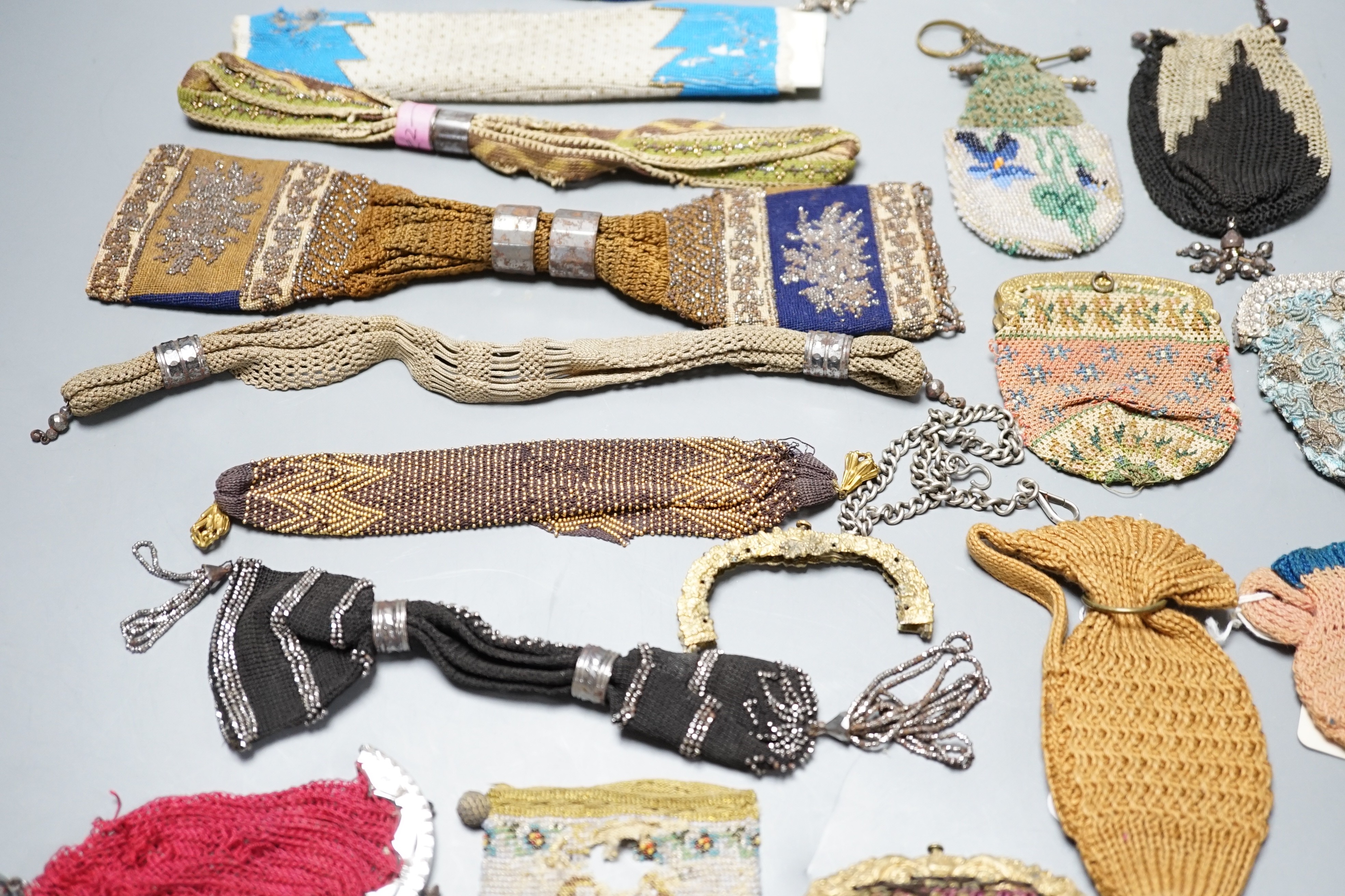 Seven 19th century cut steel misers purses, five beaded and knitted metal framed purses, two reticules, two novelty knitted jug shaped purses and two others